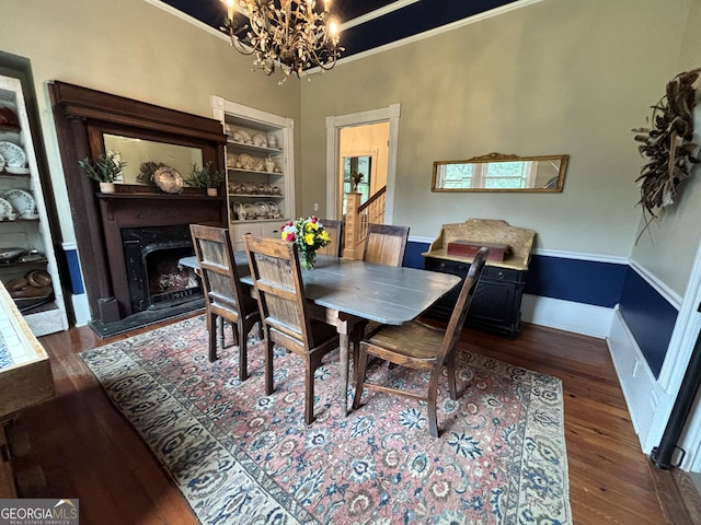 202 E Oak St, Luthersville, GA 30251 - dining room featuring a chandelier, wood finished floors, a premium fireplace, and ornamental molding