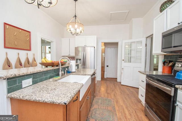 202 E Oak St, Luthersville, GA 30251 - kitchen with appliances with stainless steel finishes, a chandelier, light wood finished floors, decorative backsplash, and white cabinets