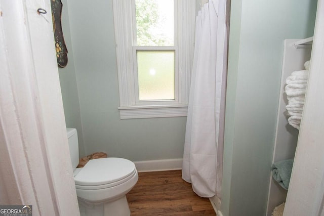 202 E Oak St, Luthersville, GA 30251 - bathroom featuring healthy amount of natural light, wood finished floors, and a shower with shower curtain
