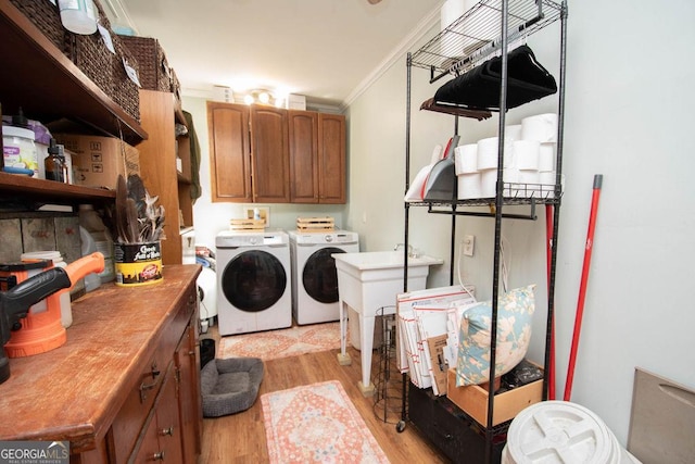 202 E Oak St, Luthersville, GA 30251 - washroom with washer and clothes dryer, crown molding, light wood finished floors, and cabinet space
