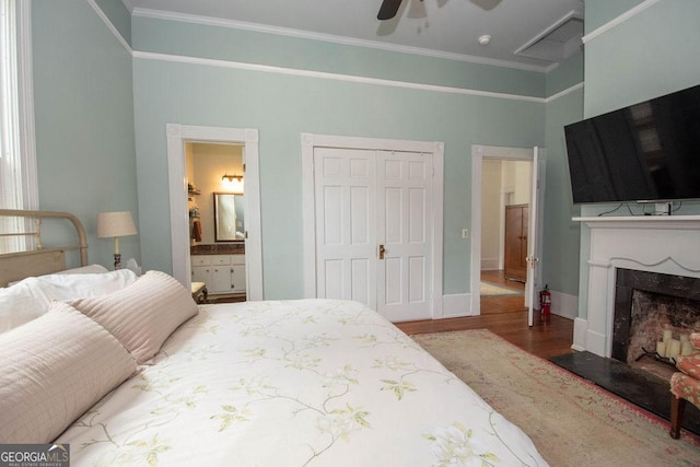 202 E Oak St, Luthersville, GA 30251 - bedroom featuring wood finished floors, ornamental molding, a closet, ensuite bath, and a fireplace