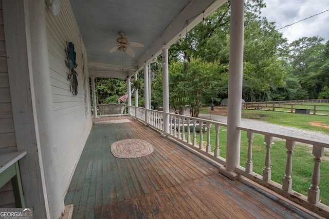 202 E Oak St, Luthersville, GA 30251 - wooden porch featuring a yard, ceiling fan, and view of wooded area
