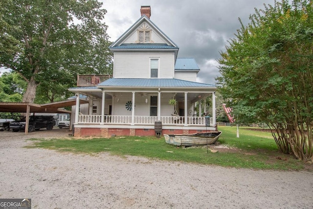 202 E Oak St, Luthersville, GA 30251 - view of front facade with covered porch, a metal roof, driveway, a chimney, and a front yard