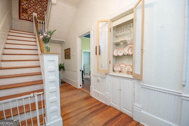 202 E Oak St, Luthersville, GA 30251 - stairs with wood finished floors, a wainscoted wall, vaulted ceiling, and a decorative wall