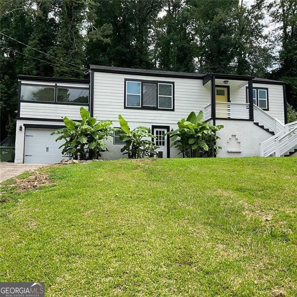 2170 Beecher Cir SW, Atlanta, GA 30311 - view of front of house with a front lawn, driveway, and a garage
