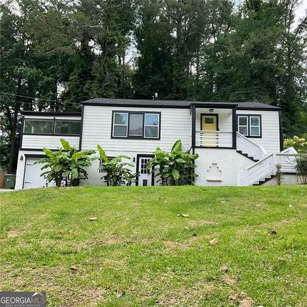 2170 Beecher Cir SW, Atlanta, GA 30311 - manufactured / mobile home with a front lawn and view of wooded area