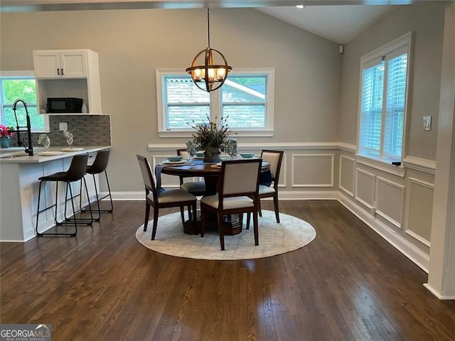 2170 Beecher Cir SW, Atlanta, GA 30311 - dining room featuring plenty of natural light, a chandelier, dark wood-style flooring, vaulted ceiling, and a wainscoted wall