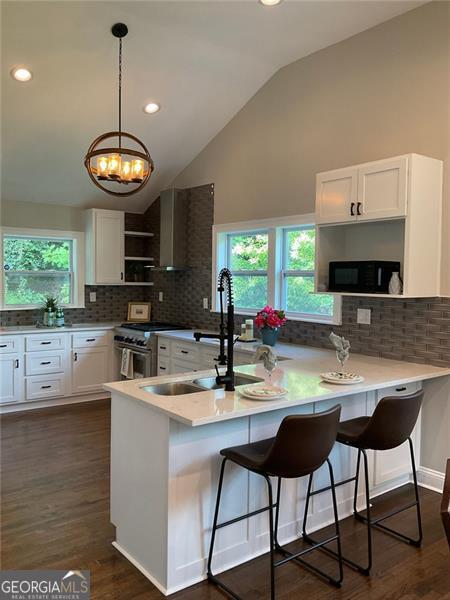 2170 Beecher Cir SW, Atlanta, GA 30311 - kitchen with open shelves, high end stove, a peninsula, white cabinets, and recessed lighting