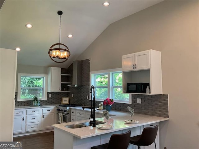 2170 Beecher Cir SW, Atlanta, GA 30311 - kitchen with open shelves, stainless steel range, a peninsula, backsplash, and white cabinets