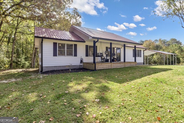 322 Pea Ridge Rd, Franklin, GA 30217 - back of property with a carport, a lawn, and a metal roof