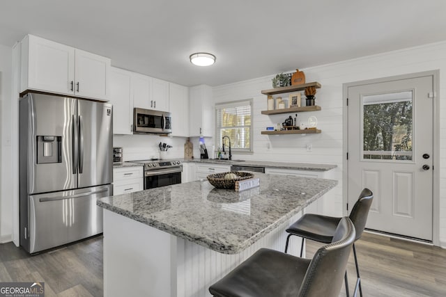 322 Pea Ridge Rd, Franklin, GA 30217 - kitchen featuring appliances with stainless steel finishes, dark wood-style floors, light stone countertops, white cabinetry, and ornamental molding