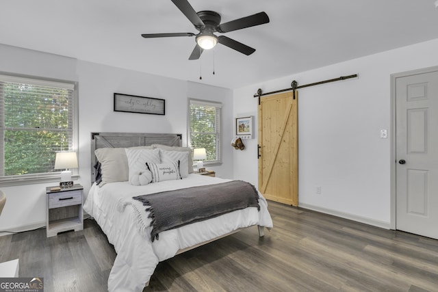 322 Pea Ridge Rd, Franklin, GA 30217 - bedroom with a barn door, wood finished floors, and ceiling fan