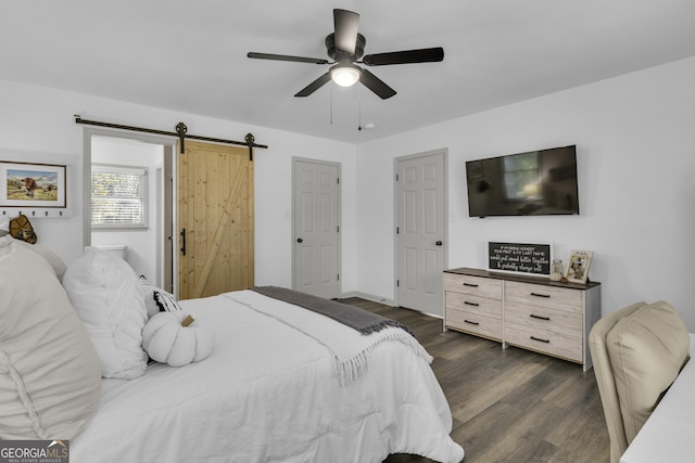 322 Pea Ridge Rd, Franklin, GA 30217 - bedroom with dark wood-style floors, a barn door, and a ceiling fan