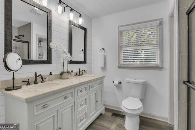 322 Pea Ridge Rd, Franklin, GA 30217 - bathroom with double vanity, a tile shower, and wood finished floors