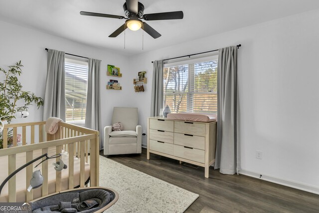 322 Pea Ridge Rd, Franklin, GA 30217 - bedroom with multiple windows, dark wood-style flooring, a nursery area, and ceiling fan