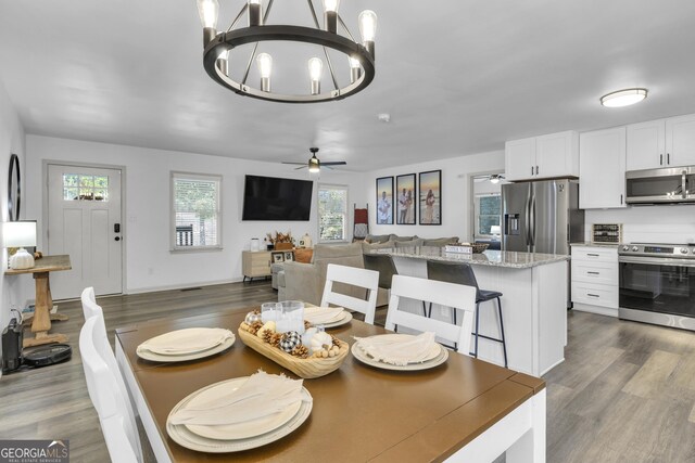 322 Pea Ridge Rd, Franklin, GA 30217 - dining space with dark wood-style floors, ceiling fan, and a chandelier