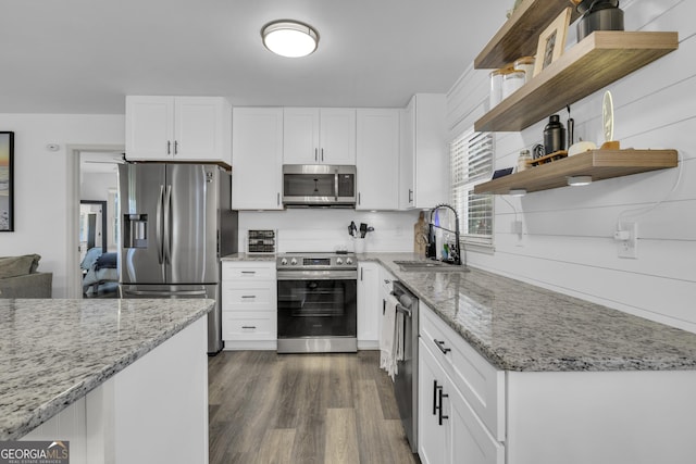 322 Pea Ridge Rd, Franklin, GA 30217 - kitchen with appliances with stainless steel finishes, open shelves, light stone counters, and white cabinetry