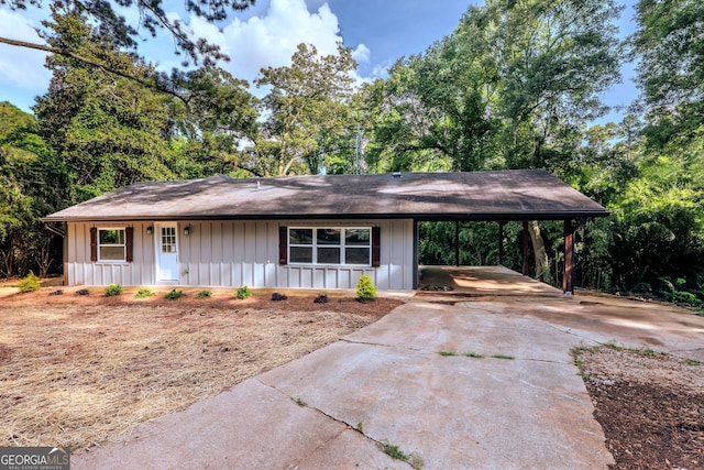206 2nd St, Gainesville, GA 30504 - view of front of house with an attached carport, concrete driveway, board and batten siding, and covered porch