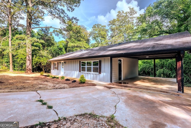 206 2nd St, Gainesville, GA 30504 - view of front of home with concrete driveway, an attached carport, board and batten siding, and a shingled roof