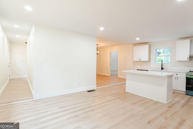 206 2nd St, Gainesville, GA 30504 - kitchen featuring stainless steel range with electric stovetop, white cabinetry, light wood-style floors, and recessed lighting