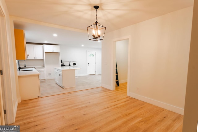 206 2nd St, Gainesville, GA 30504 - kitchen with a kitchen island, recessed lighting, white cabinets, light wood finished floors, and decorative light fixtures