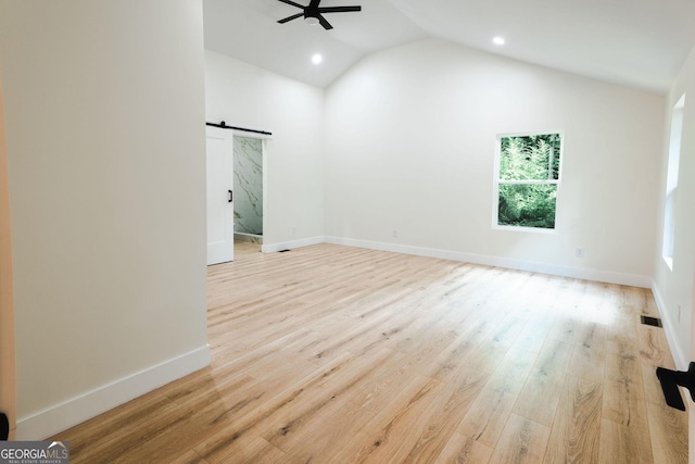 206 2nd St, Gainesville, GA 30504 - spare room with a barn door, ceiling fan, lofted ceiling, recessed lighting, and wood finished floors