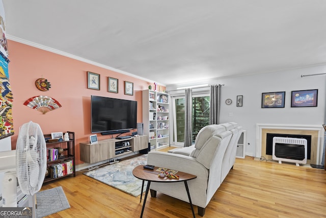5400 Roswell Rd Apt L 6, Sandy Springs, GA 30342 - living room featuring wood finished floors, crown molding, a fireplace with flush hearth, and heating unit