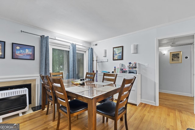5400 Roswell Rd Apt L 6, Sandy Springs, GA 30342 - dining space featuring ornamental molding, light wood-type flooring, and heating unit