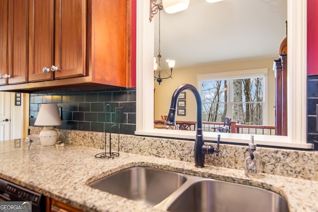 705 Laurel Ridge Dr, Ellijay, GA 30536 - kitchen with brown cabinetry, decorative backsplash, light stone countertops, and dishwasher