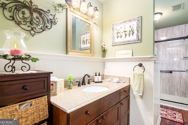 705 Laurel Ridge Dr, Ellijay, GA 30536 - bathroom featuring vanity, a stall shower, and a wainscoted wall