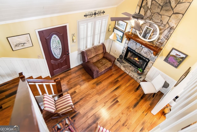 705 Laurel Ridge Dr, Ellijay, GA 30536 - living room with ornamental molding, wood-type flooring, a stone fireplace, and wainscoting