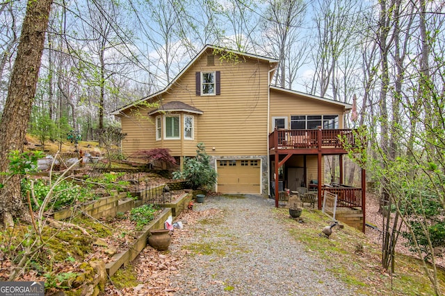 705 Laurel Ridge Dr, Ellijay, GA 30536 - view of front facade featuring gravel driveway, a garage, a sunroom, and a wooden deck