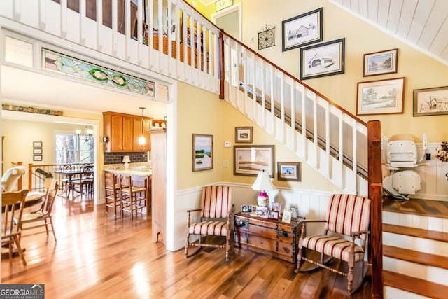 705 Laurel Ridge Dr, Ellijay, GA 30536 - stairs featuring wood finished floors, a wainscoted wall, and high vaulted ceiling