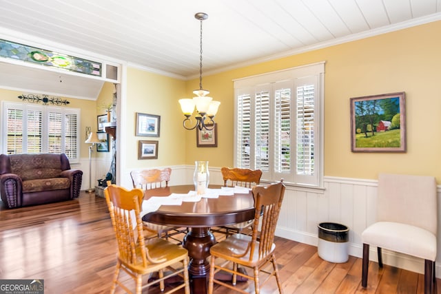 705 Laurel Ridge Dr, Ellijay, GA 30536 - dining room featuring hardwood / wood-style flooring, a chandelier, wainscoting, and crown molding
