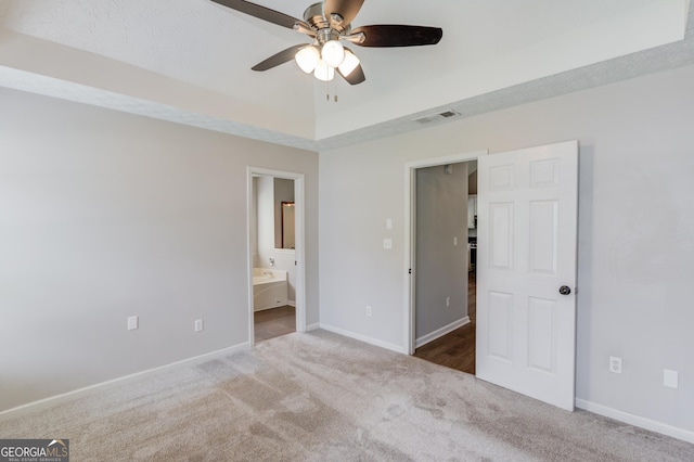 926 Masters Dr, Monroe, GA 30655 - unfurnished bedroom with carpet, ensuite bathroom, a raised ceiling, and a ceiling fan