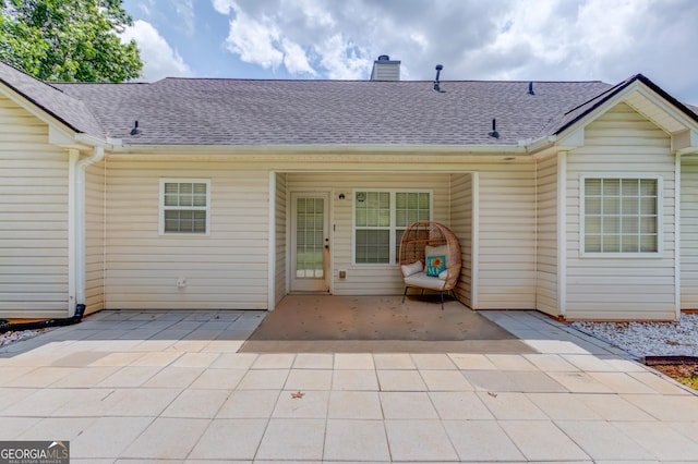 926 Masters Dr, Monroe, GA 30655 - rear view of house with a chimney, a shingled roof, and a patio area