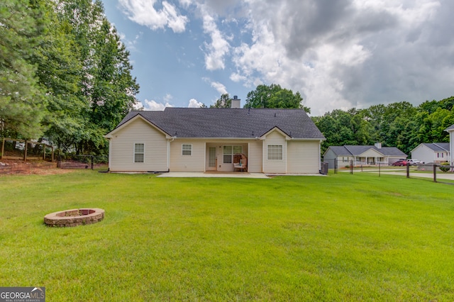 926 Masters Dr, Monroe, GA 30655 - back of property featuring a fire pit, a patio area, and a chimney