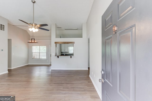 926 Masters Dr, Monroe, GA 30655 - foyer featuring ceiling fan, light wood-style flooring, vaulted ceiling, and a chandelier