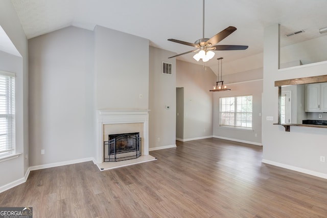 926 Masters Dr, Monroe, GA 30655 - unfurnished living room featuring a fireplace with raised hearth, ceiling fan, light wood-type flooring, and high vaulted ceiling