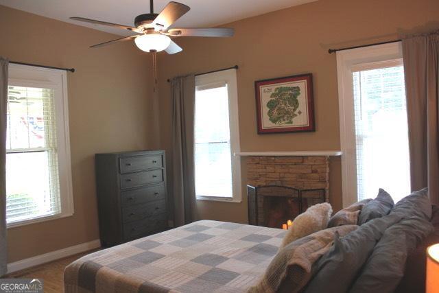 5880 Mulberry St, Austell, GA 30168 - bedroom featuring multiple windows, a fireplace, and ceiling fan