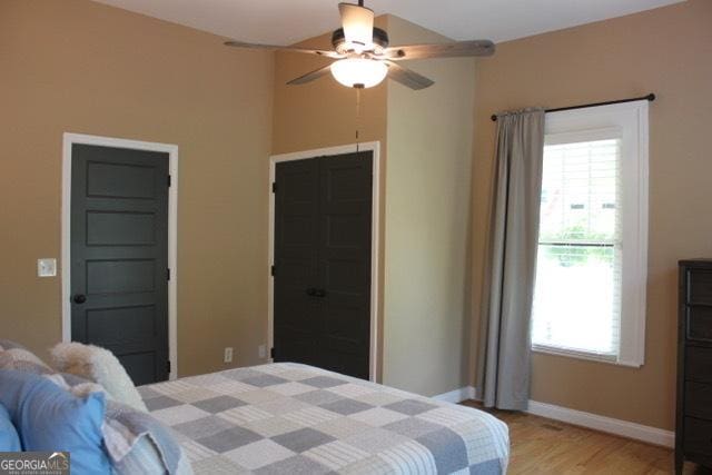 5880 Mulberry St, Austell, GA 30168 - bedroom featuring light wood-type flooring, multiple windows, and ceiling fan