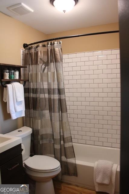 5880 Mulberry St, Austell, GA 30168 - bathroom with wood finished floors, shower / tub combo, and vanity