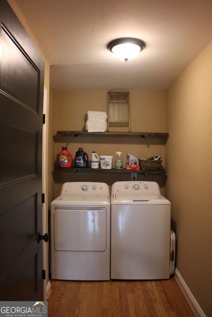 5880 Mulberry St, Austell, GA 30168 - laundry room featuring washing machine and clothes dryer and wood finished floors