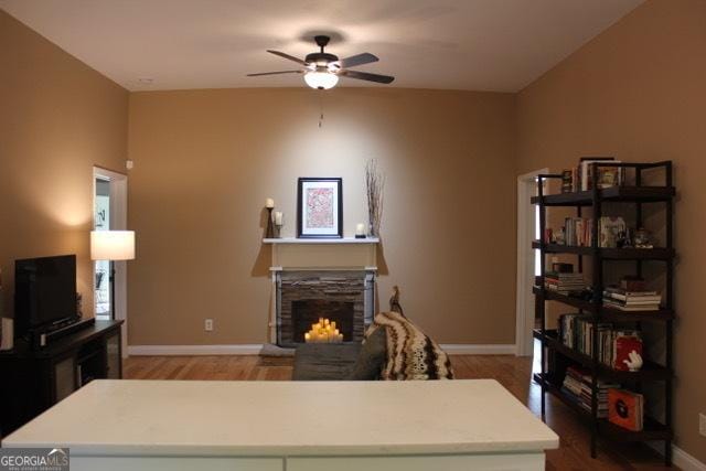 5880 Mulberry St, Austell, GA 30168 - living area with a stone fireplace, ceiling fan, and light wood-style floors