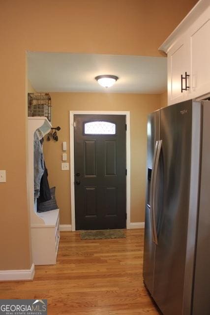 5880 Mulberry St, Austell, GA 30168 - foyer entrance featuring light wood finished floors and baseboards
