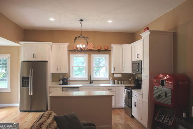 5880 Mulberry St, Austell, GA 30168 - kitchen with stainless steel appliances, light wood-style floors, white cabinetry, and recessed lighting