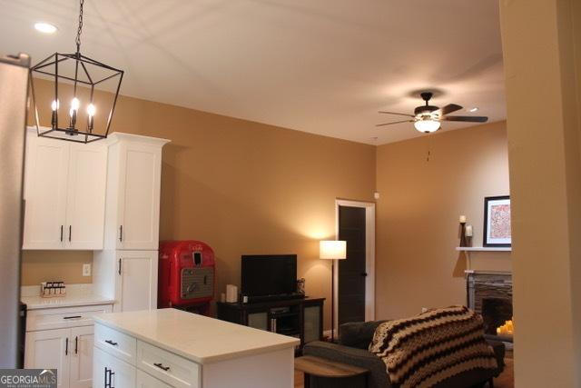 5880 Mulberry St, Austell, GA 30168 - living area featuring a chandelier, a fireplace, and a ceiling fan