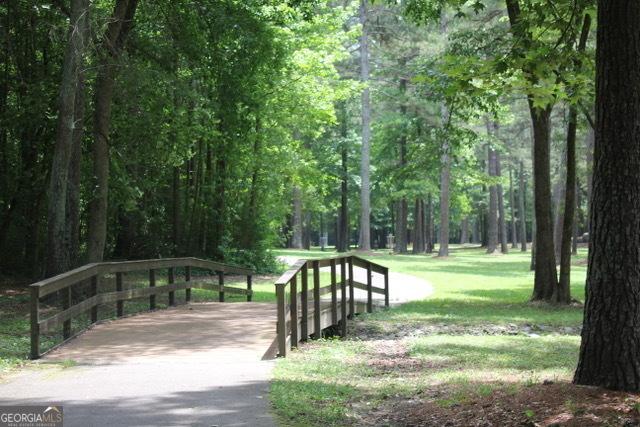 5880 Mulberry St, Austell, GA 30168 - surrounding community with a lawn and a view of trees