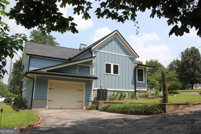 5880 Mulberry St, Austell, GA 30168 - view of front of property with board and batten siding and driveway