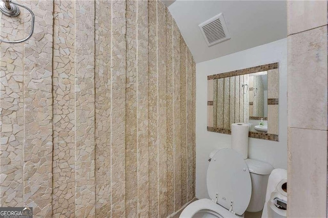 2232 Dunseath Ave NW Unit 309, Atlanta, GA 30318 - bathroom featuring toilet and lofted ceiling